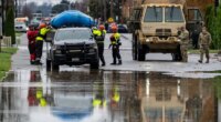 Emergency crews, including National Guard soldiers, wort in a neighborhood flooded by the Skagit River on Friday, Dec. 12, 2025, in Burlington, Wash. (AP Photo/Stephen Brashear)