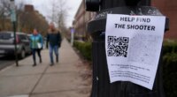 A poster seeking information about the campus shooting suspect is seen on the campus of Brown University, Wednesday, Dec. 17, 2025, in Providence, R.I. (AP Photo/Robert F. Bukaty)