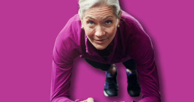 Mature woman, plank and gym on floor with balance for strong core muscle with vision for wellness. Person, training and workout for abdomen, stomach and challenge for development at fitness club