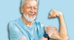 Portrait of a happy positive old senior man showing biceps and power standing outdoors in park or nature, healthy lifestyle, active senior, vitality and humor concepts