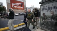 U.S. Border Patrol Commander at large Gregory Bovino, 3rd left, walks on the street in New Orleans, La.,Wednesday, Dec. 3, 2025. (AP Photo/Gerald Herbert)
