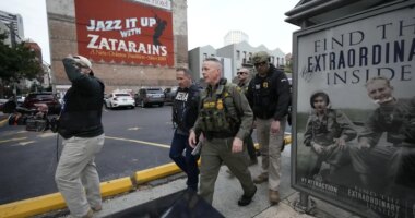U.S. Border Patrol Commander at large Gregory Bovino, 3rd left, walks on the street in New Orleans, La.,Wednesday, Dec. 3, 2025. (AP Photo/Gerald Herbert)