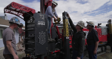 Matthew, Anna, Nathan and Matt Cooper prepare to drill a hole for a geothermal heat pump installation Thursday, Oct. 9, 2025, in Hamilton, Colo. (AP Photo/Brittany Peterson)