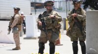 FILE - Members of the California National Guard and U.S. Marines guard a federal building on Tuesday, June 17, 2025, in Los Angeles. (AP Photo/Damian Dovarganes, File)