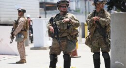 FILE - Members of the California National Guard and U.S. Marines guard a federal building on Tuesday, June 17, 2025, in Los Angeles. (AP Photo/Damian Dovarganes, File)