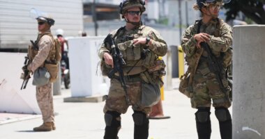 FILE - Members of the California National Guard and U.S. Marines guard a federal building on Tuesday, June 17, 2025, in Los Angeles. (AP Photo/Damian Dovarganes, File)