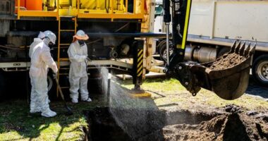 Cleanup workers are seen undertaking maintenance on a sewage pipe in Wentworth Park.