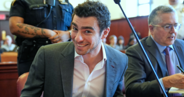 Luigi Mangione smiles for cameras in court as defense claims police violated his rights