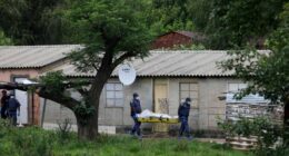 Police officers carry the body of a person on a stretcher after a mass shooting at a bar near Pretoria, South Africa, Saturday, Dec. 6, 2025. (AP Photo)
