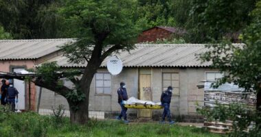 Police officers carry the body of a person on a stretcher after a mass shooting at a bar near Pretoria, South Africa, Saturday, Dec. 6, 2025. (AP Photo)