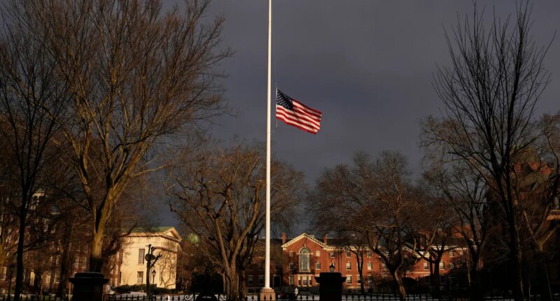 The U.S. flag flies at half-staff on the Main Green in honor of the victims of the campus shooting at Brown University, Wednesday, Dec. 17, 2025, in Providence, R.I. (AP Photo/Robert F. Bukaty)