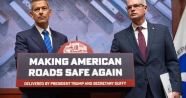 Transportation Secretary Sean Duffy, left, and Derek Barrs, Administrator of the Federal Motor Carrier Safety Administration, listen to a reporter