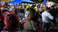 A little girl holds a doll, one of many gifts distributed at dozens of open-air altars to the Virgin Mary, as Nicaraguan parishioners of St. John Bosco Catholic Church celebrate the Dec. 8 feast of the Immaculate Conception, Sunday, Dec. 7, 2025, in Miami. (AP Photo/Rebecca Blackwell)