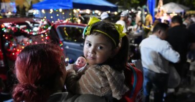 A little girl holds a doll, one of many gifts distributed at dozens of open-air altars to the Virgin Mary, as Nicaraguan parishioners of St. John Bosco Catholic Church celebrate the Dec. 8 feast of the Immaculate Conception, Sunday, Dec. 7, 2025, in Miami. (AP Photo/Rebecca Blackwell)