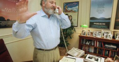 FILE - Rob Reiner talks on the phone at his office at Castle Rock Enterprises, seeking donations for anti-smoking campaigns, July 29, 1988, in Beverly Hills, Calif. (AP Photo/Reed Saxon, File)