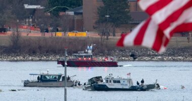 FILE - A diving team and police boat is seen near a wreckage site in the Potomac River, from Ronald Reagan Washington National Airport, Jan. 30, 2025, in Arlington, Va. (AP Photo/Jose Luis Magana, File)