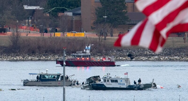 FILE - A diving team and police boat is seen near a wreckage site in the Potomac River, from Ronald Reagan Washington National Airport, Jan. 30, 2025, in Arlington, Va. (AP Photo/Jose Luis Magana, File)