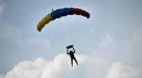 Skydiver survives after reserve parachute accidentally deploys, leaving him dangling from flying airplane