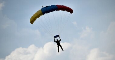 Skydiver survives after reserve parachute accidentally deploys, leaving him dangling from flying airplane