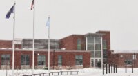 A Somali flag is flies alongside the United States and Vermont flags outside the Winooski School District building Wednesday, Dec. 10, 2025, in Winooski, Vt. (AP Photo/Amanda Swinhart)