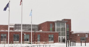 A Somali flag is flies alongside the United States and Vermont flags outside the Winooski School District building Wednesday, Dec. 10, 2025, in Winooski, Vt. (AP Photo/Amanda Swinhart)