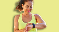Middle age hispanic woman working out with smart watch at promenade