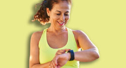 Middle age hispanic woman working out with smart watch at promenade