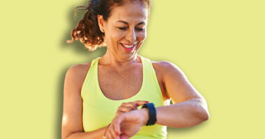 Middle age hispanic woman working out with smart watch at promenade