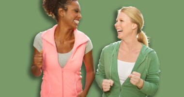 Happy fitness woman lifting dumbbells smiling and energetic.