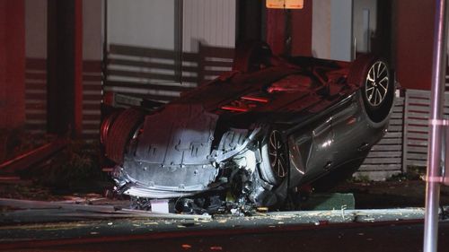 Two men were pulled from the overturned wreck of the Toyota Corolla.