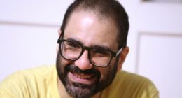 Pro-democracy activist Alaa Abd el-Fattah, who was in prison for almost all of the past 12 years, speaks to his friends at his home after he got a presidential pardon, in Cairo, Tuesday, Sept. 23, 2025. (AP Photo/Khaled Elfiqi, File)