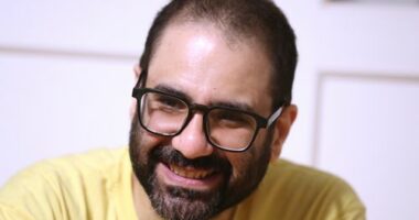 Pro-democracy activist Alaa Abd el-Fattah, who was in prison for almost all of the past 12 years, speaks to his friends at his home after he got a presidential pardon, in Cairo, Tuesday, Sept. 23, 2025. (AP Photo/Khaled Elfiqi, File)