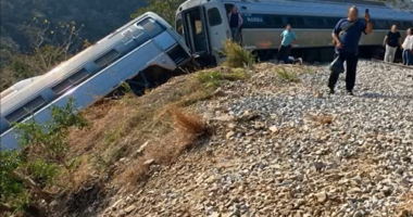 Passengers were seen on the railway tracks after escaping from the crashed train.