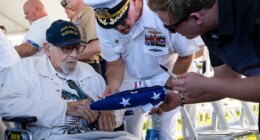 FILE - An attendee asks Pearl Harbor survivor Ira