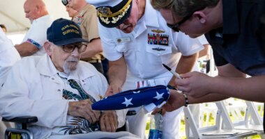 FILE - An attendee asks Pearl Harbor survivor Ira