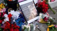 Flowers, challenge coins and other items lay near a photograph of U.S. Army Spc. Sarah Beckstrom at a makeshift memorial outside of Farragut West Station, near the site where two National Guard members were shot, Monday, Dec. 1, 2025, in Washington. (AP Photo/Julia Demaree Nikhinson)