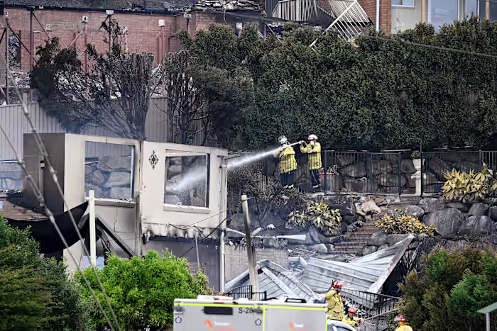 Wildfires destroy 40 homes and kill a firefighter in Australia