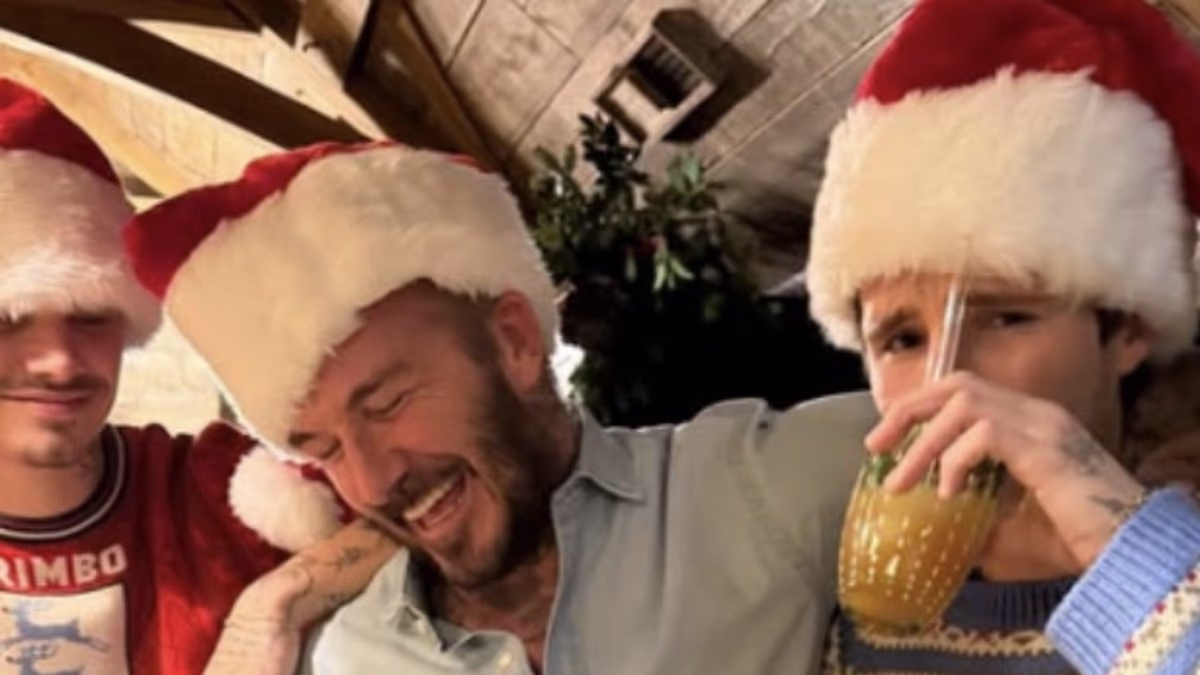 Wish you were here Brooklyn! David Beckham and his boys celebrate Christmas in festive Santa hats after eldest son's thinly veiled barb