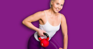 Fitness girl in one arm row position with a kettlebell