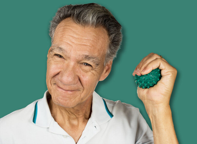 Mature man holding and squeezing massage therapy spike balls