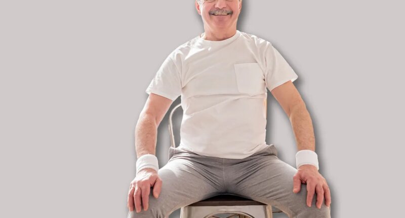 Elderly man wearing sport clothing sitting on chair ready for online yoga lesson