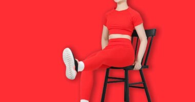 Beautiful woman stretching on chair at home, space for text