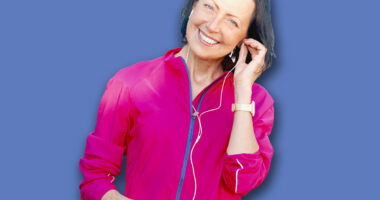 Mature woman listen music before or after jog in the park. Attractive looking mature woman keeping fit and healthy