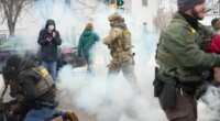 Tear gas is deployed as Federal agents make arrests on Wednesday, Jan. 21, 2026, in Minneapolis. (AP Photo/Angelina Katsanis)