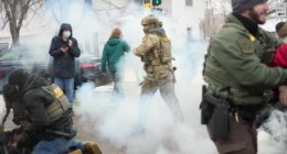 Tear gas is deployed as Federal agents make arrests on Wednesday, Jan. 21, 2026, in Minneapolis. (AP Photo/Angelina Katsanis)