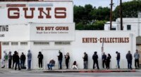 FILE - People wait to enter a gun store in Culver City, Calif., March 15, 2020. (AP Photo/Ringo H.W. Chiu, File)