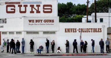 FILE - People wait to enter a gun store in Culver City, Calif., March 15, 2020. (AP Photo/Ringo H.W. Chiu, File)