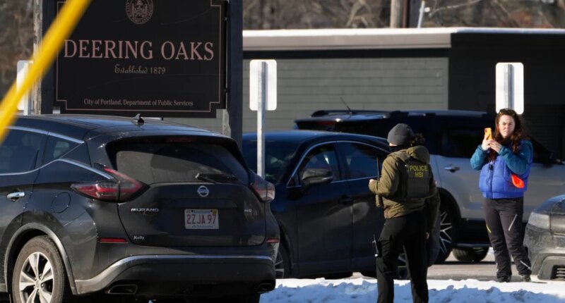 A woman films a Homeland Security Investigations agent at a parking lot at Deering Oaks Park, Friday, Jan. 23, 2026, in Portland, Maine.(AP Photo/Robert F. Bukaty)
