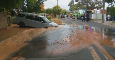 A couple's drive to the airport has taken a shocking turn after their hire car fell into a large sinkhole in Adelaide.