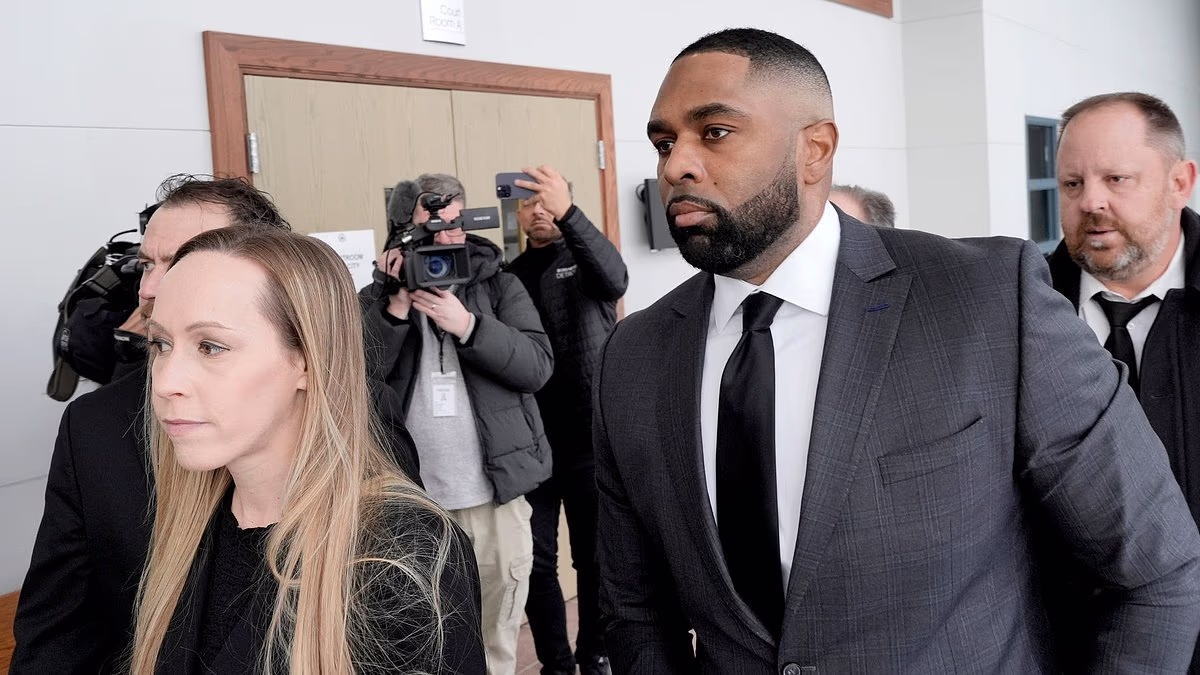 Ex-Michigan coach Moore is joined by loyal wife for court appearance